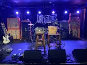 A photo of a stage in Whelan's with musical equipment on it.